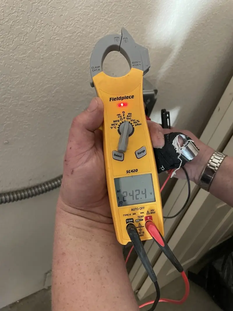 Voltage testing with clamp meter during Whole House Surge Protector in St. James